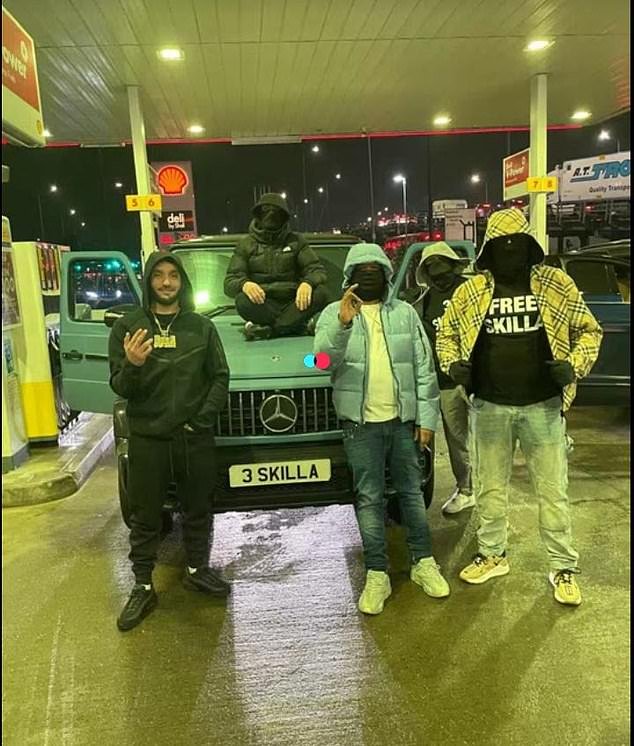 Hellbanianz member known by the nickname 'OneMilli' (left) and others posing at a Shell gas station in Barking with the number plate '3 Skilla' - his brother who is in prison